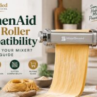 KitchenAid pasta roller compatibility: kitchenaid pasta roller attachment connected to a red stand mixer with fresh pasta sheets showing compatibility, installation, and cutter guidance.